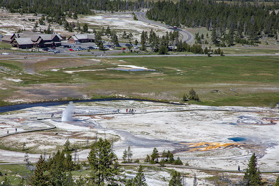 Looking down into the Upper Geyser Basin from Observation Point. Plume Geyser is in eruption in this 2012 picture.